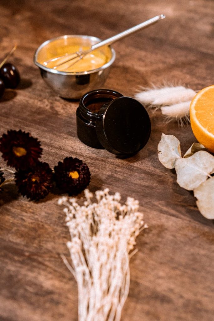 made-at-home-cosmetics-4827704 Top-down view of natural cosmetic ingredients surrounded by dried flowers and an orange slice.